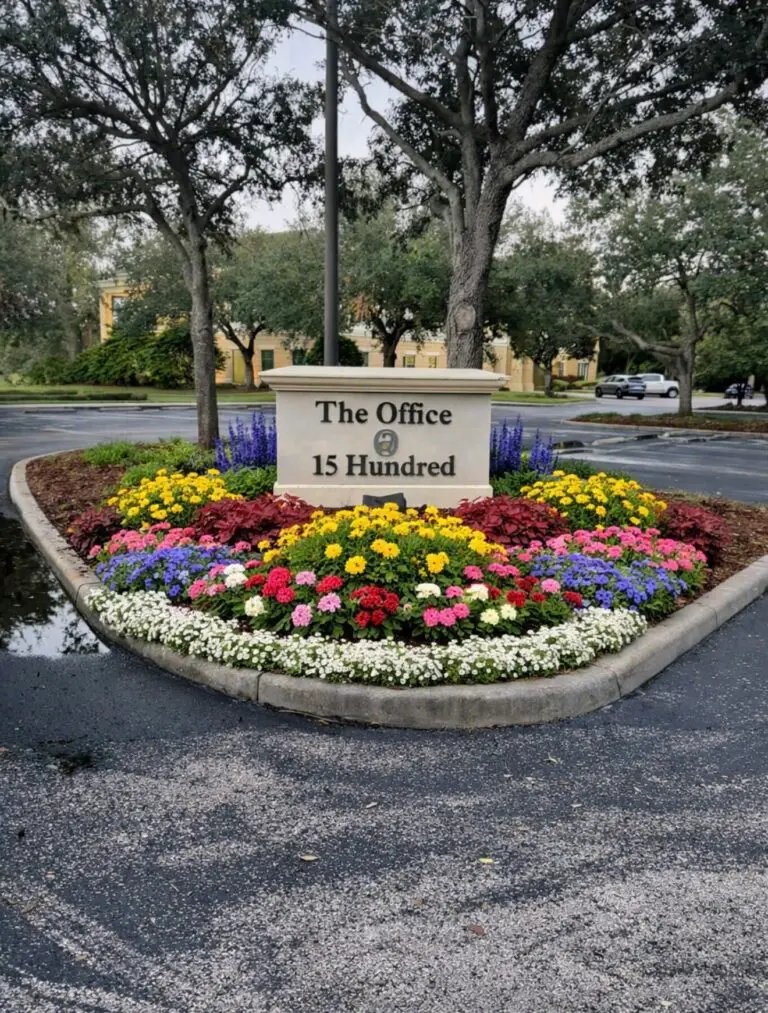 Commercial property entrance landscape design featuring decorative plants, mulch beds, and professional curb appeal improvements in Clermont, FL.
